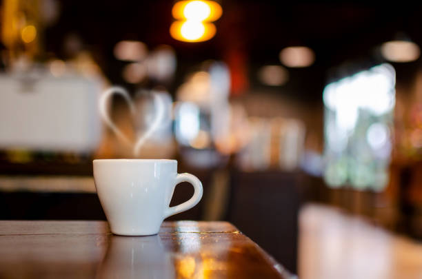 istock Hot Coffee Cup on Wood Table in blurred Coffee Shop background. 1245986946