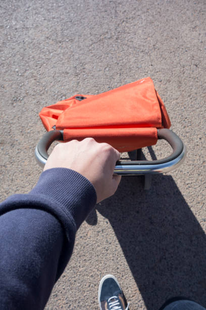 istock man pushing an orange shopping cart 1245991385
