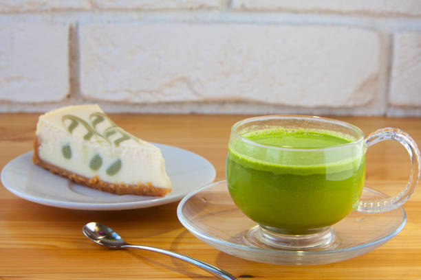appetizing green cheesecake with matcha tea on a wooden background