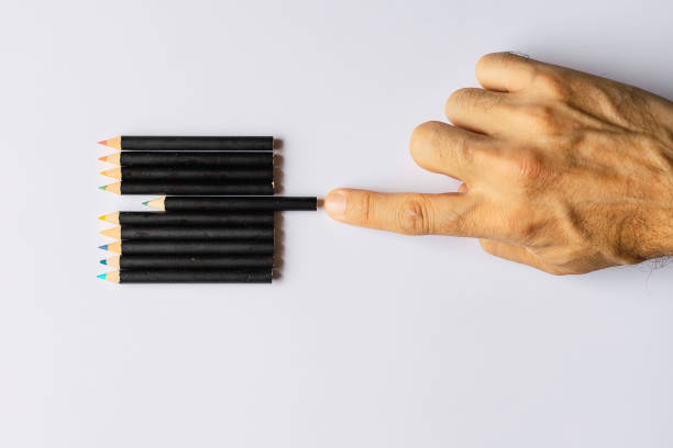 Obsessive compulsive disorder, male hand obsessively ordering some colored pencils\nConceptual psychological problem, OCD
