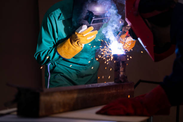 istock Metal welding steel works using electric arc welding machine 1246028988
