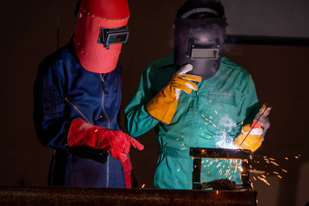 istock Metal welding steel works using electric arc welding machine 1246029015