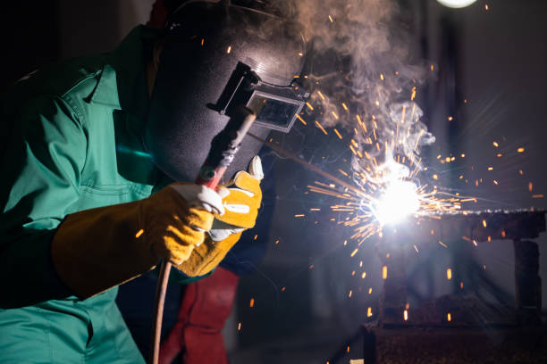 istock Metal welding steel works using electric arc welding machine 1246029016
