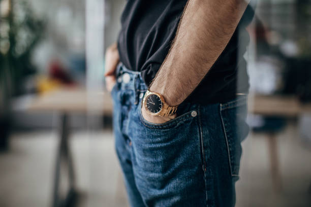 Young businessman's hand in pocket wearing a watch.