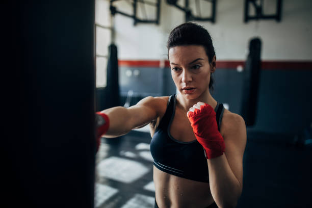 istock Female boxer training alone in gym 1246029086