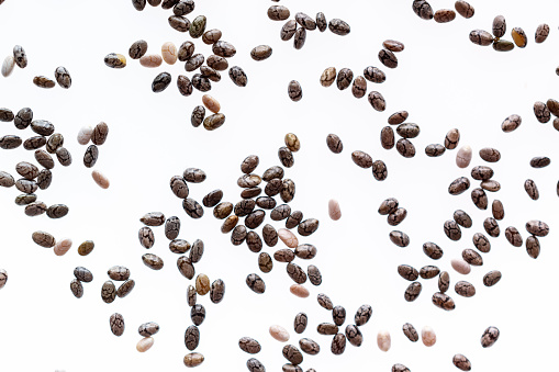 Small group of chia seeds isolated on white background. Closeup. Top view. Chia super food.