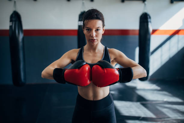 istock Female boxer standing alone in gym 1246029330