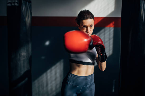 istock Female boxer standing alone in gym 1246029426