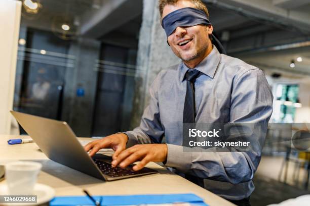 Blindfolded Businessman Unable To See The Reality Over Computer In The Office Stock Photo - Download Image Now