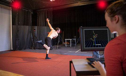 A shot of two people orchestrating a sport science experiment at a university in Perth, Australia. They are tracking the movement of an athlete