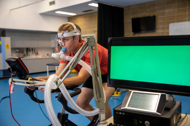 Testing Athletes A shot of a student in a sports science laboratory performing a VO2 Max Test at a university in Perth, Australia. checking sports stock pictures, royalty-free photos & images