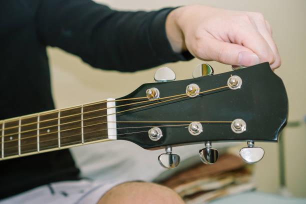 istock Hand Tunning Acoustic Guitar 1246093008