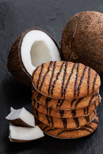 istock Chocolate coconut cookies on black stone background 1246094185