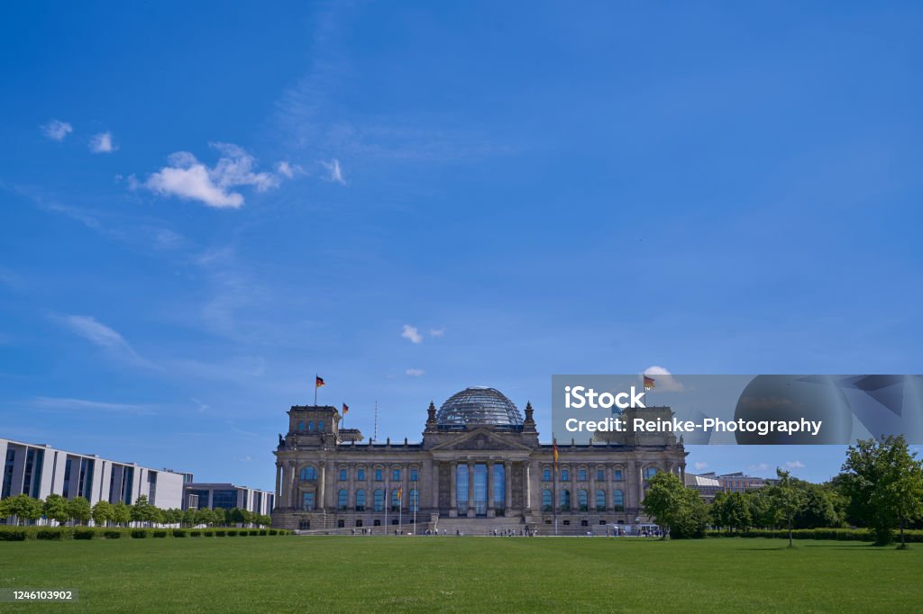 Reichstag with Platz der Republik in the foreground and blue sky Coronavirus Stock Photo