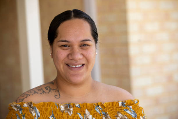 Female Portrait Close-up portrait of a young Pacific Islander woman, standing in front of her home. pacific islander ethnicity stock pictures, royalty-free photos & images