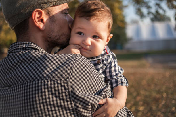 istock Father holding his son outdoors 1246109912