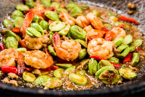 Frying  bitter beans with shrimps  in pan