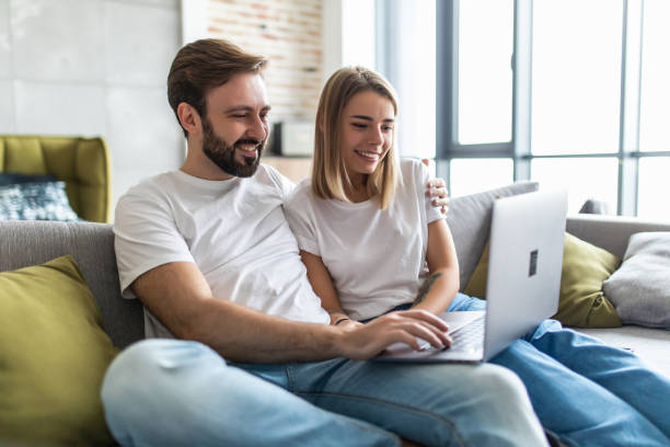 istock Portrait of a couple using a laptop on the couch 1246118948