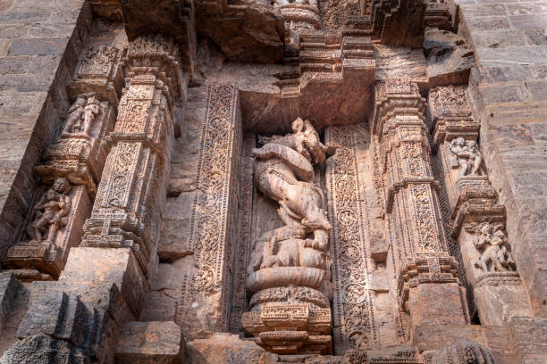 Intricate sculptures stone carving on the walls of the ancient Hindu Sun Temple in Konark, Orissa, India. 13th-century CE. Close-up view.