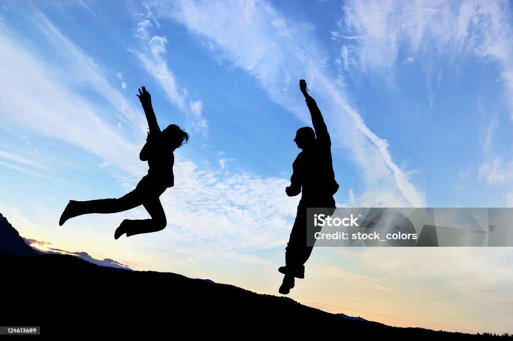 attraction couple jumping one to each other to be together Jumping Stock Photo