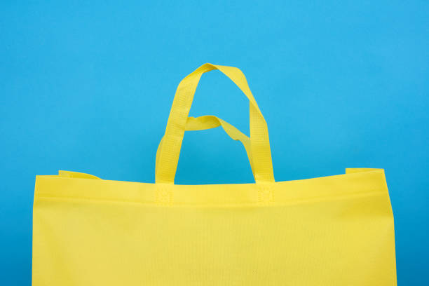 istock reusable yellow viscose bag on blue background 1246140488