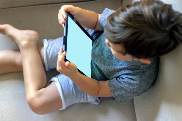 istock Toddler playing with tablet at home. 1246149974