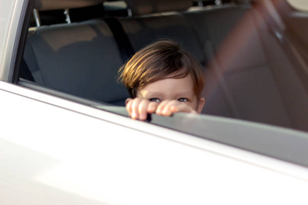 istock Boy looking out of car window. 1246151098