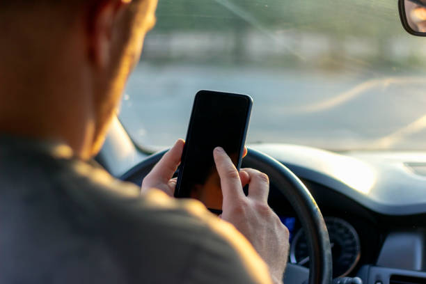 istock Rear view of young male using mobile device. 1246153379