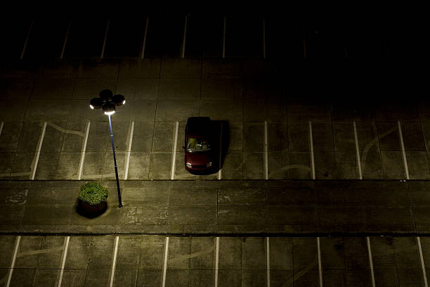 parking lot at night nightshot of a desolate parking lot (note: car has been altered for licence plate and logo) dark street stock pictures, royalty-free photos & images