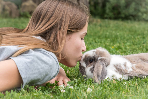 istock Teenager kissing her rabbit 1246154473