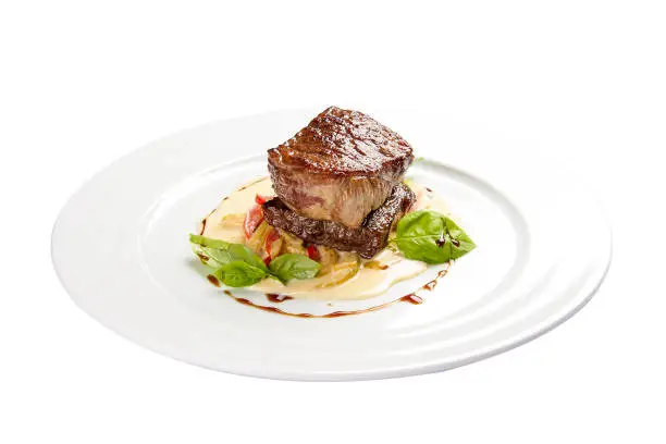 Veal medallion with vegetables. On a white background