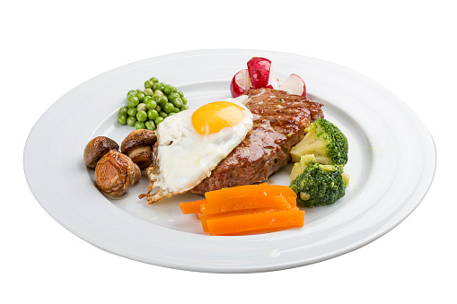 An average breakfast. Steak, egg and vegetables. On a white background