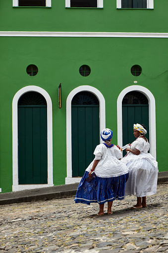 Brazilian woman of African descent wearing traditional Baiana costume in the historic center of Salvador, Bahia, Brazil.