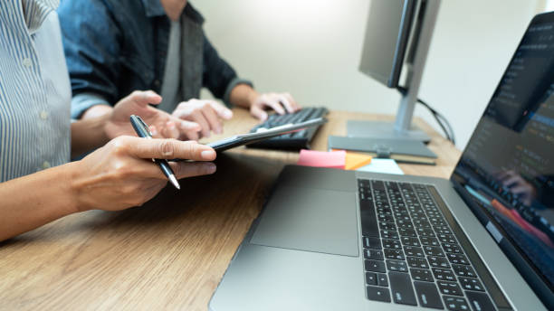 istock Cropped Image Of People Using Laptop On Table 1246168605