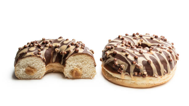 istock Doughnuts covered with chocolate and caramel icing isolated on white 1246176706