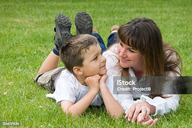 Mother And Son On The Grass Stock Photo - Download Image Now - 25-29 Years, 30-39 Years, 6-7 Years