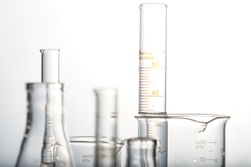 A collection of scientific glassware - beakers, flasks, graduated cylinders.