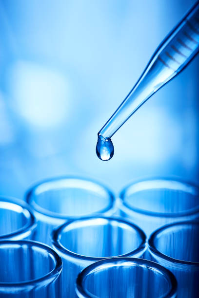 istock Single drop of liquid leaving pipette 1246181410
