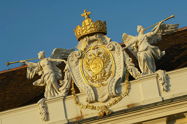 the coat of arms and statues on the roof of the imperial apartments (Kaiserappartements) in hofburg complex. vienna. austria. europe.
