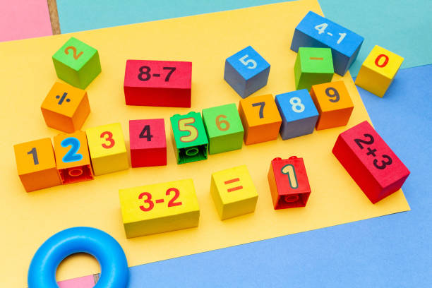 istock child kid colorful education toys cubes with numbers math pattern background on the bright background. Flat lay. Childhood infancy children babies concept. 1246196326
