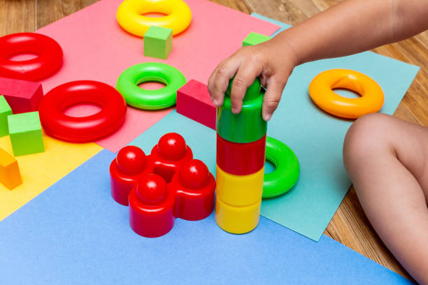 istock child kid playing colorful education toys pattern background on the bright background. Childhood infancy children babies concept. 1246197446