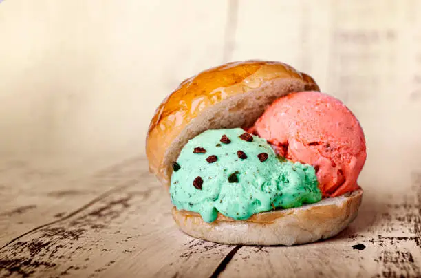 Photo of strawberry and mint ice cream ball inside a milk bread roll