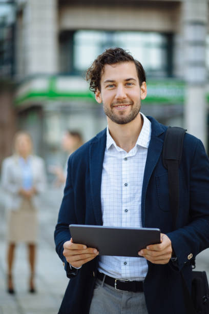 istock Young businessman using digital tablet outdoors 1246214684