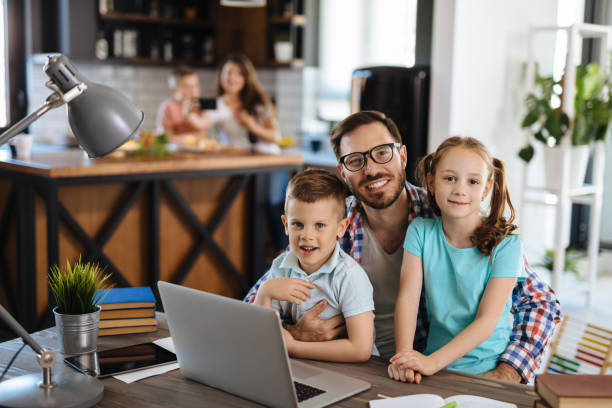 istock Kids having fun at home, playing with their father, using laptop 1246223869