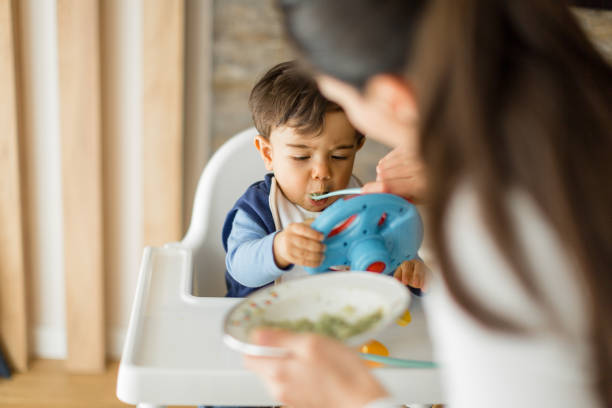 istock Mother feeding her baby boy 1246225011