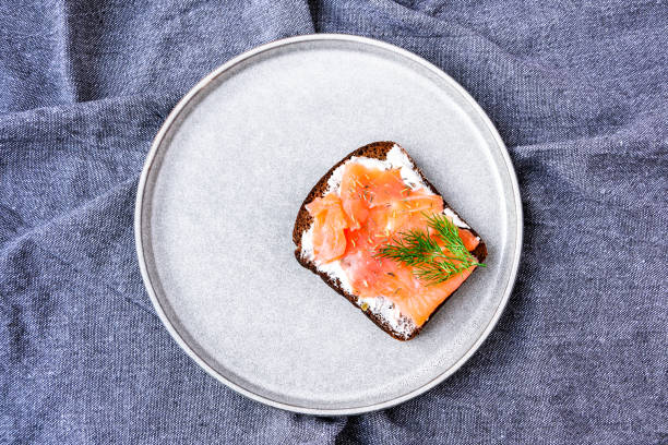 istock Salmon healthy toast with cheese on plate on kitchen towel 1246236932