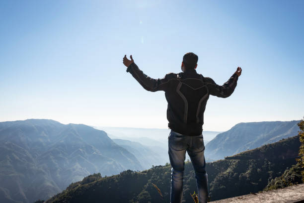 istock man showing victory at mountain range covered with white mist 1246282963
