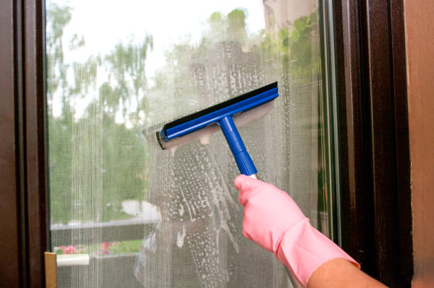 istock Hand in rubber glove cleaning balcony window with squeegee , wash glass. Cleaning service. Housekeeping. 1246285708