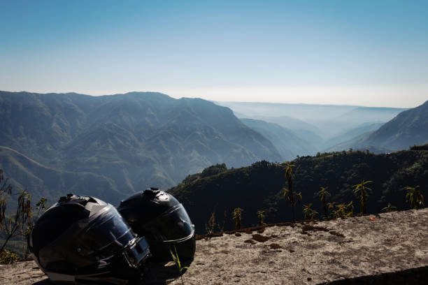 白い霧で覆われた山脈のカップルライダーのヘルメット - two lane highway 写真 ストックフォトと画像