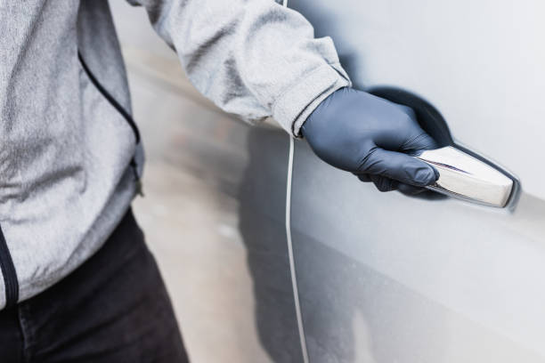 istock The thief pull up the door handle to Stealing a car. The vehicle insurance concept. 1246289738